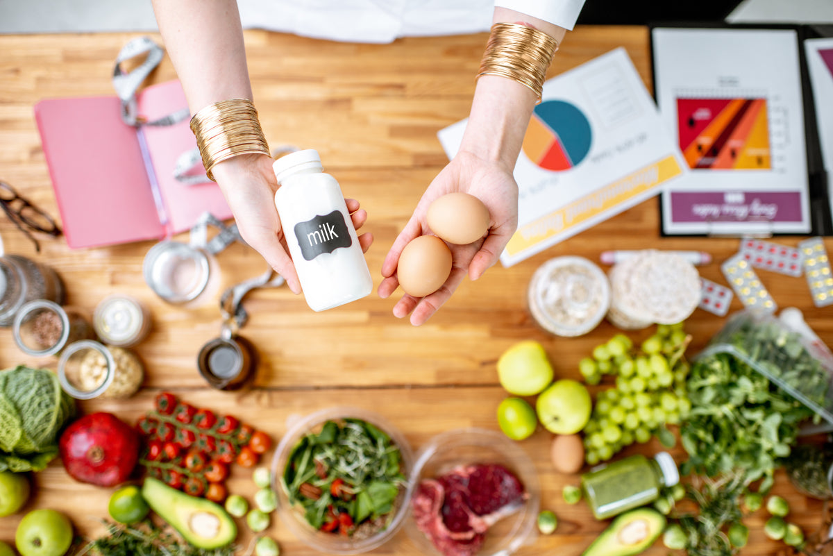 dietitian-holding-eggs-and-milk-above-the-table-fu.jpg